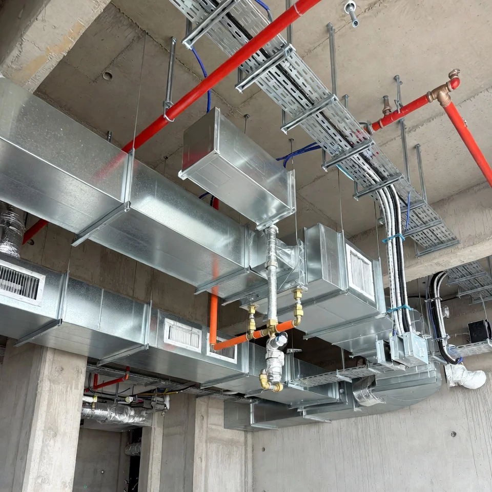 Realistic photo of exposed MEP installations in a building